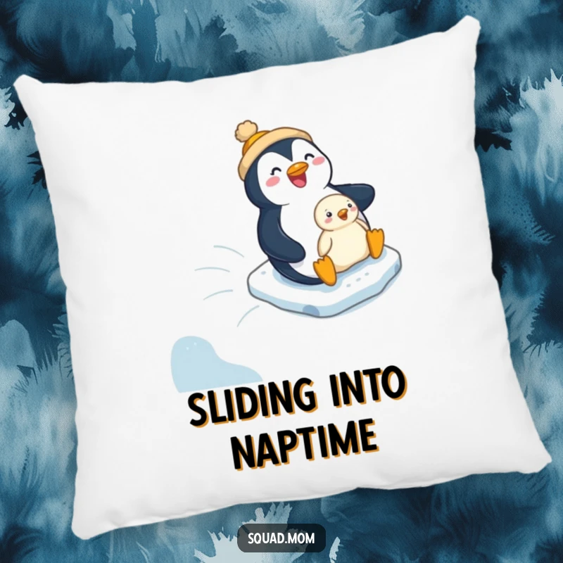 Funny penguin mom and chick on a winter slide, depicted on a soft, humorous pillow for cozy decor.