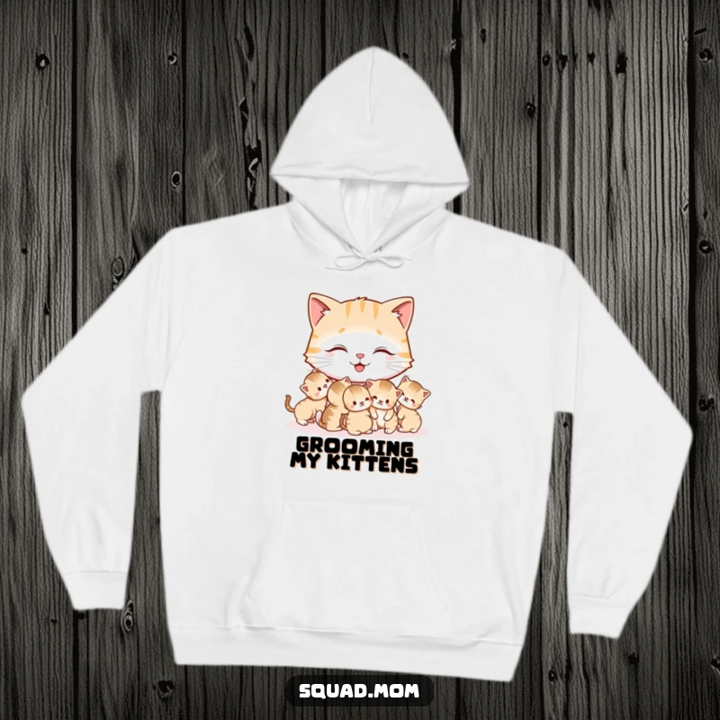 Funny Cat Mom Hoodie depicting a joyful mother cat gently grooming her litter of tiny kittens, a heartwarming and humorous design.