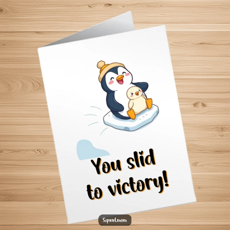 Funny Free Printable Congratulation Card: Penguin mom and chick joyfully slide down an icy slope, celebrating success.