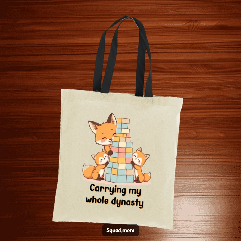Funny tote bag illustration of a mother fox and playful kits stacking blocks, a humorous accessory and gift.